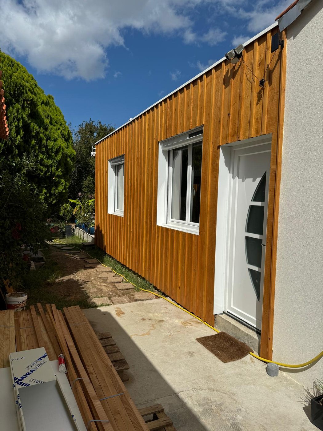 Bardage bois vertical et pose de menuiseries sur une extension de maison, réalisé par A2Roulet-Toiture
